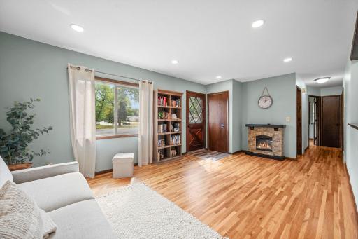 Living room anchored by a stone-surround electric fireplace
