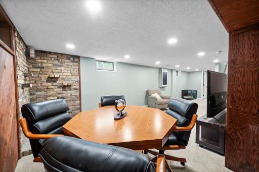 Game nook with vintage brick accent & warm wood paneling