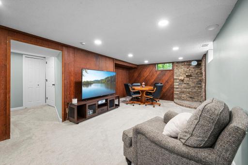 Lower-level family room with plush carpet & recessed lighting