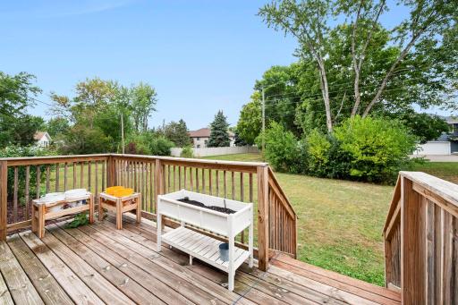 Deck overlooks the sprawling backyard & garden planters
