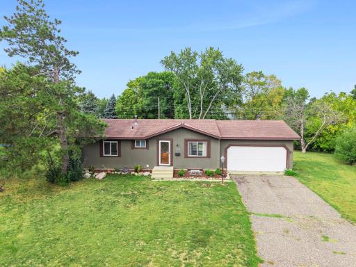 Classic rambler profile with fresh landscaping & attached two-car garage