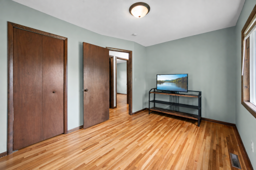 First of three main-level bedrooms with hardwood floors & corner windows