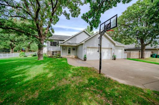 Attached garage and driveway w/basketball hoop