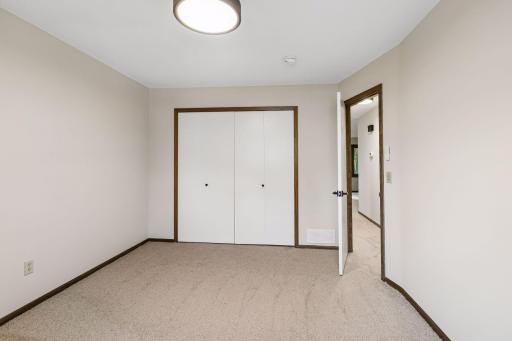 One of three upper-level bedrooms, the primary bedroom features fresh paint, new carpeting, and a comfortable layout. All three bedrooms and the full bathroom are conveniently located on the same level.