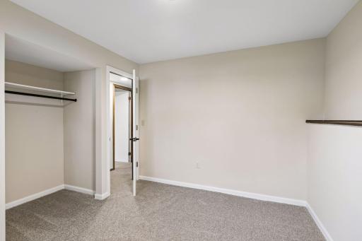 The second lower-level flex space features an open closet. A perfect space to equip with built in shelving for additional or off-season storage!