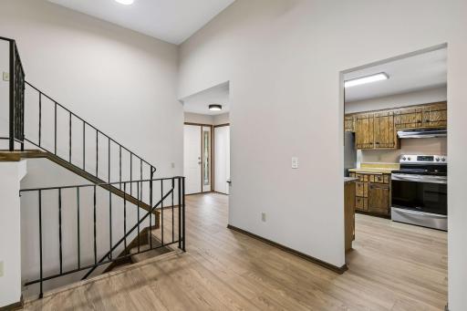 The new luxury vinyl tile flooring brings warmth and character to the main level, creating a seamless flow between the entry, kitchen and dining areas. Its natural wood tones beautifully complement the home's existing finishes.