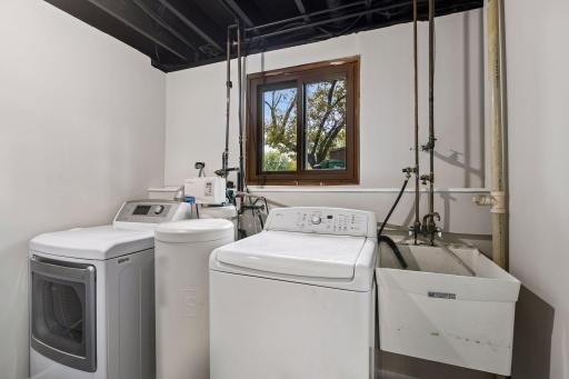 Freshened up and ready to go! The lower-level laundry/utility room features freshly painted walls, ceiling and floors, along with a convenient utility sink and water softener.