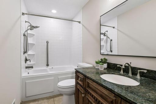 The upper-level full bathroom offers a well-designed layout with great functionality. Fresh paint, new lighting and a stylish mirror complement the granite-topped vanity plus the tub/shower surround with convenient built-in shelving.