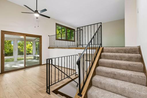 The open iron railing system allows for unobstructed views between levels, adding to the home's open and inviting feel.