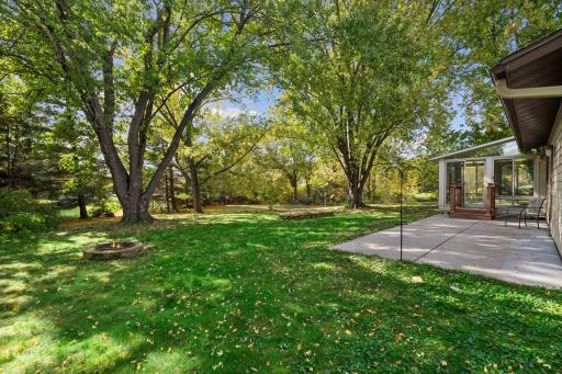 Enjoy the peaceful setting of this beautifully wooded .46-acre lot, featuring a three-season porch overlooking the backyard and a generous 29 x 11-foot concrete patio, perfect for outdoor entertaining and relaxation.