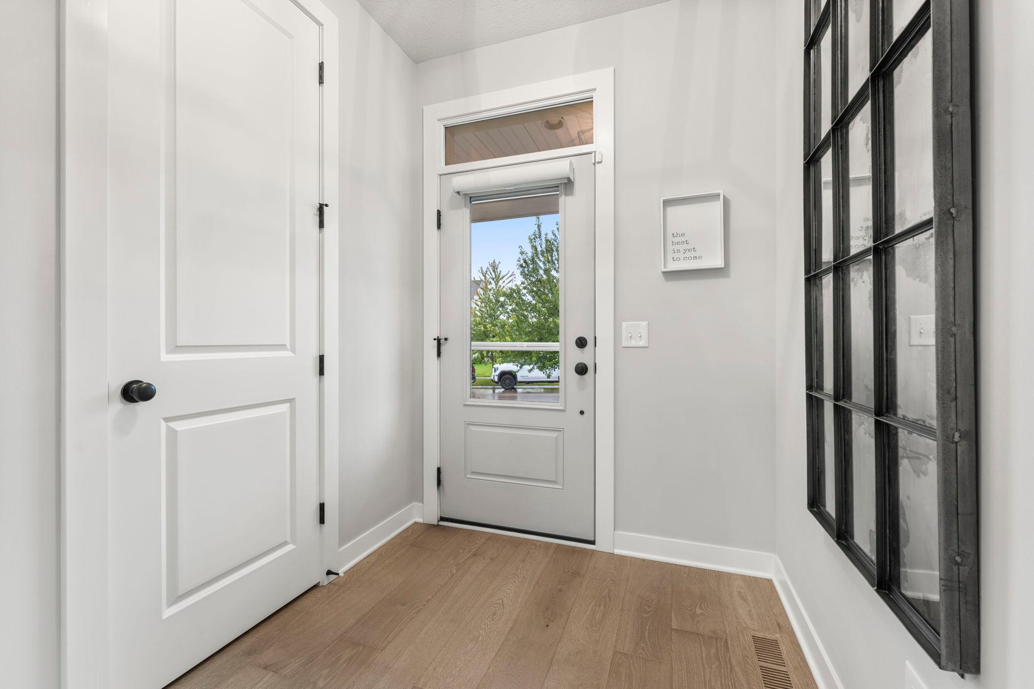 The bright foyer features luxury vinyl tile floors and a convenient spacious coat closet.