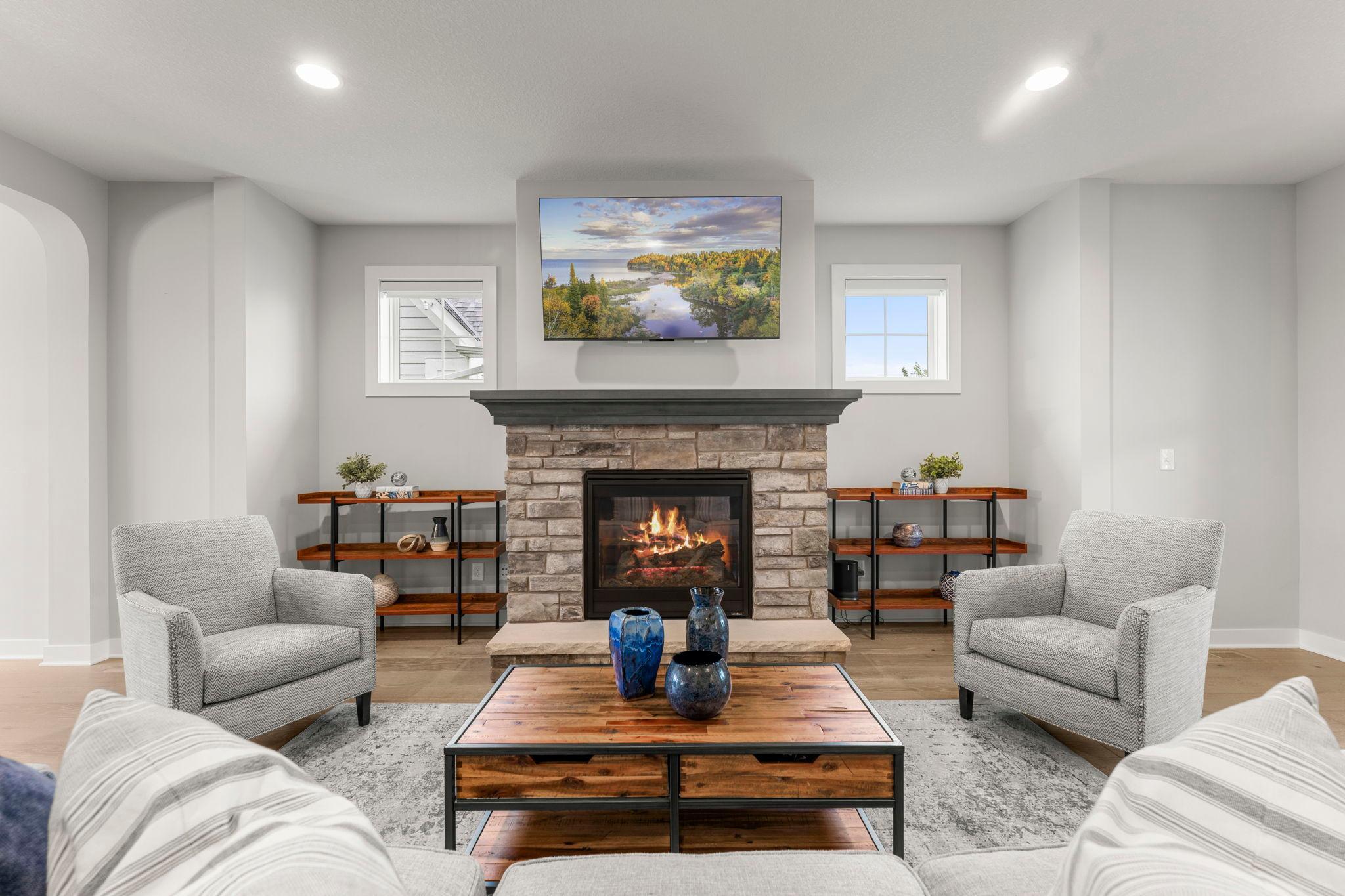 The fireplace is flanked by two accent windows, bringing in extra natural light without interrupting the wall space.