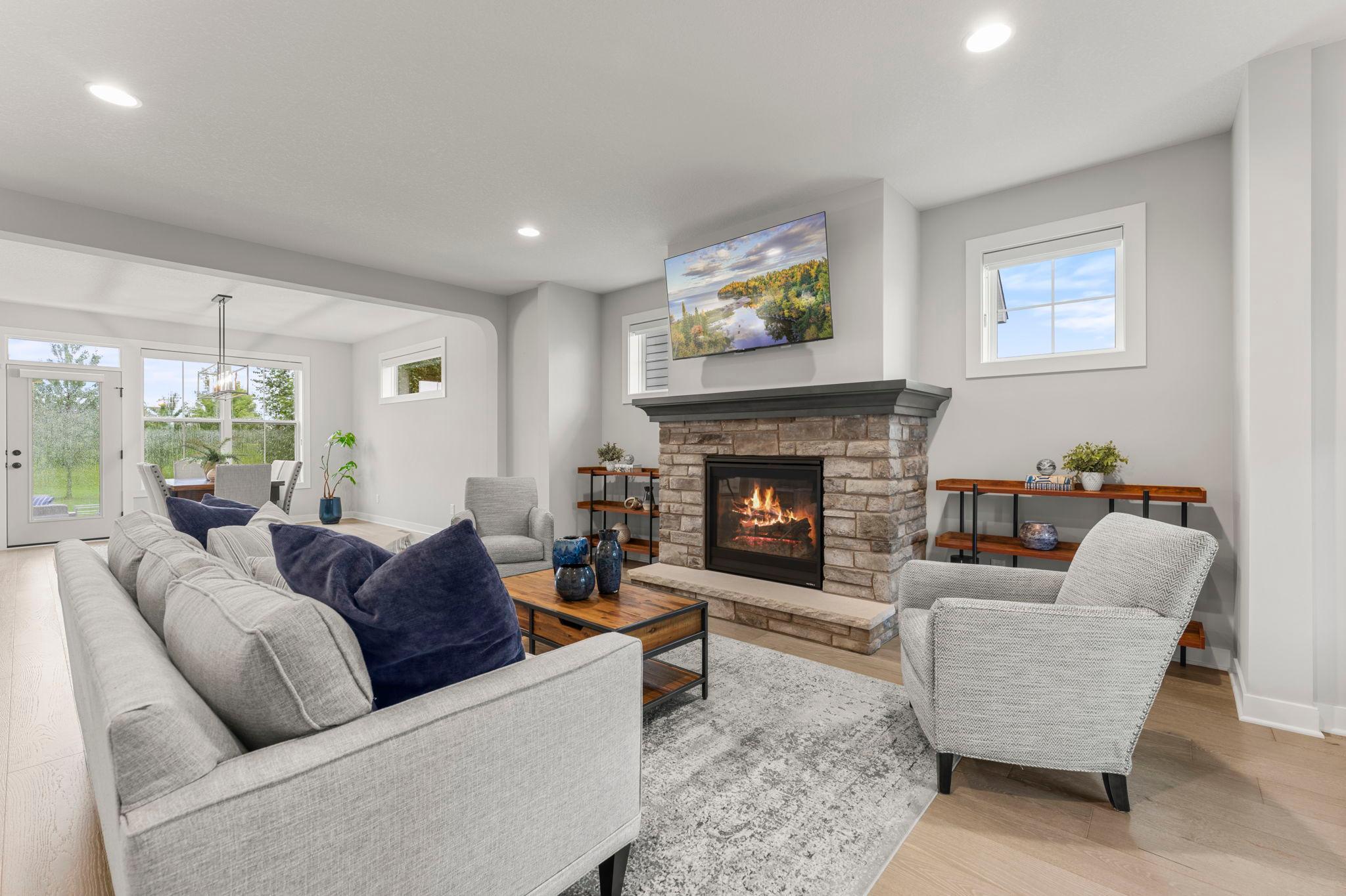 The main-level open-concept layout is filled with natural light. It features 9 ft knockdown ceilings, 8 ft doors, luxury vinyl tile, 2-panel wood doors, ceramic tile floors, and recessed lights.