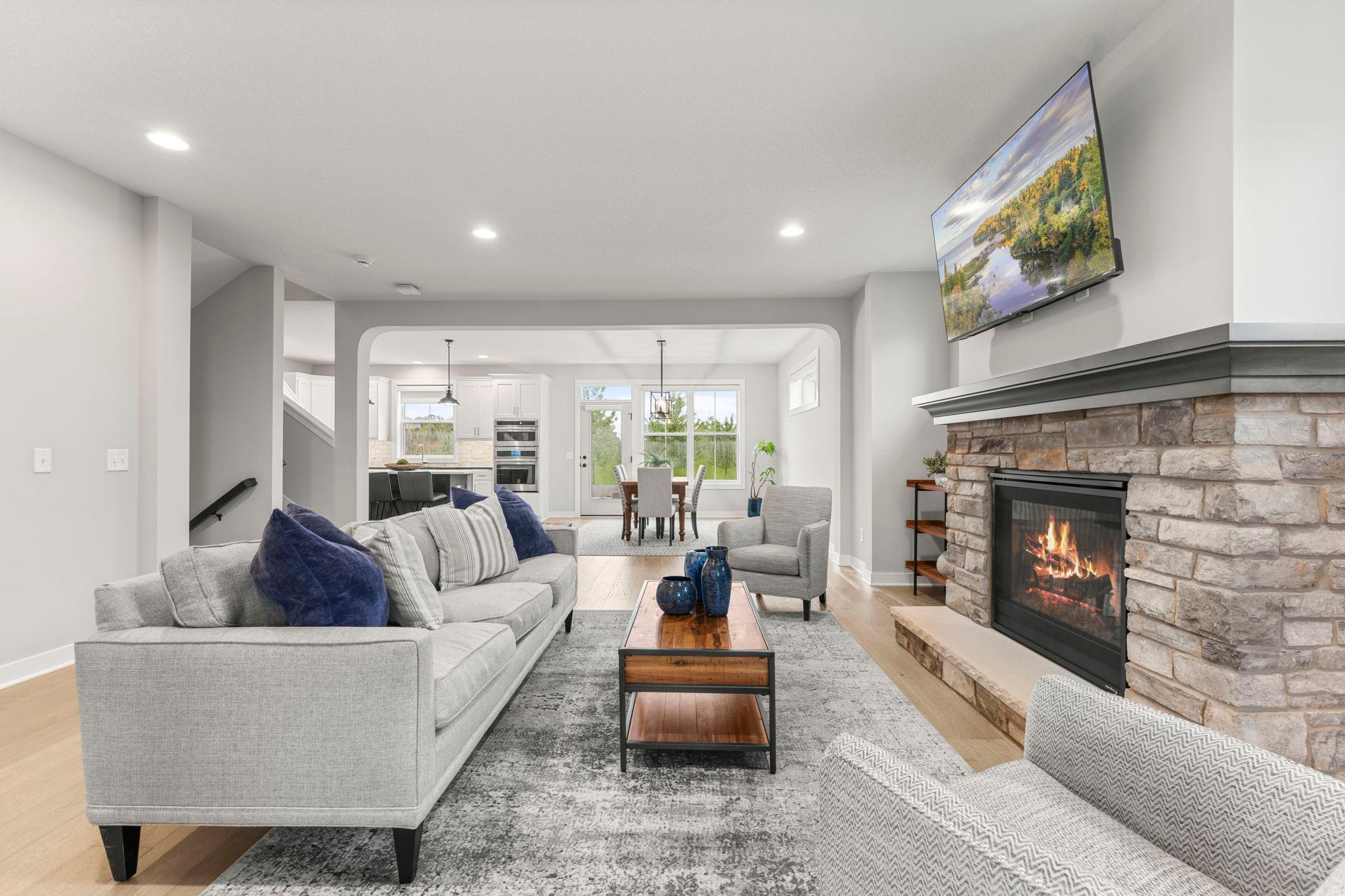 This view of the living room showcases the layout of the informal dining room and kitchen.
