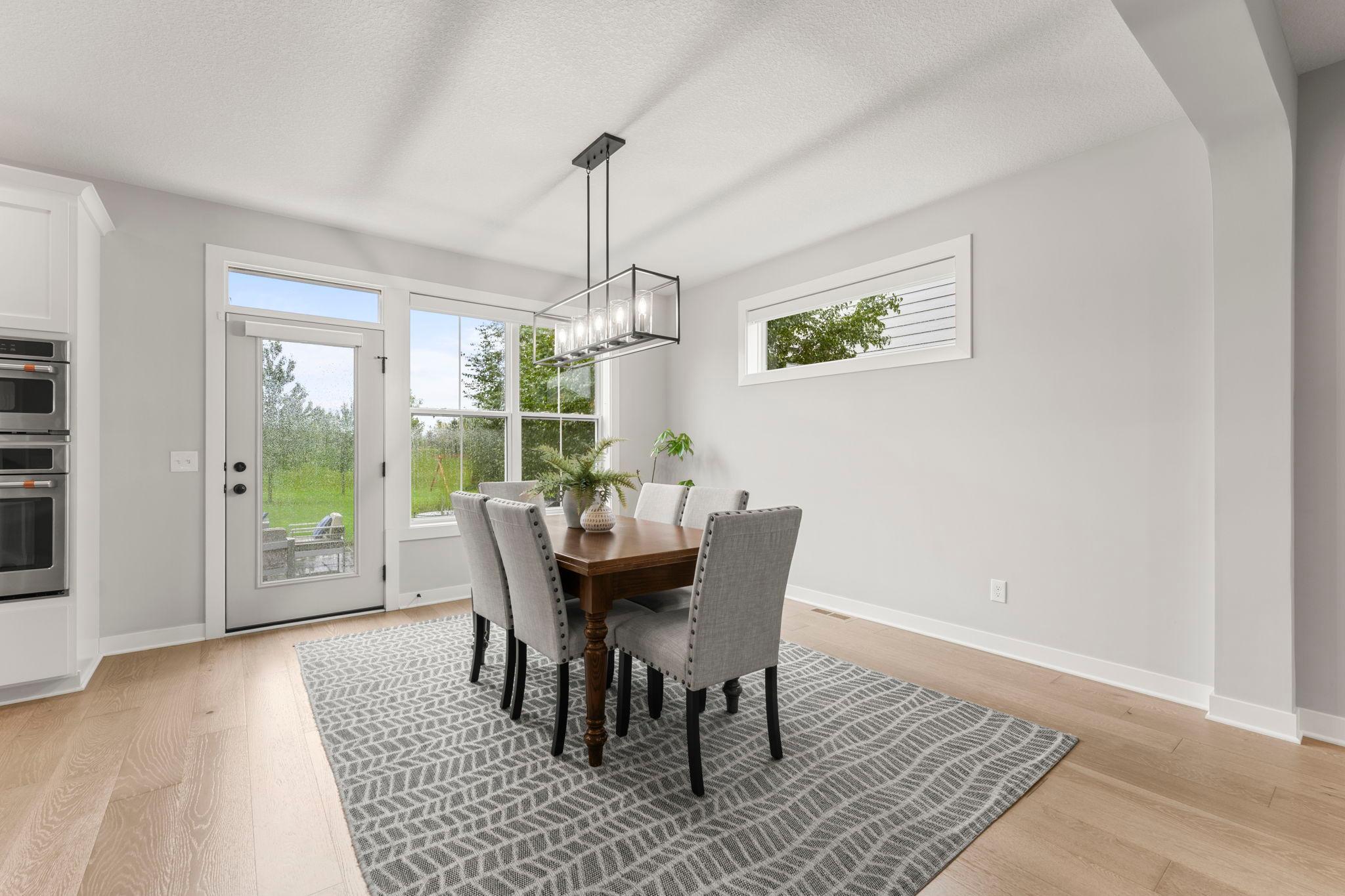The spacious, light-filled informal dining room accommodates a large dining room set with ease.