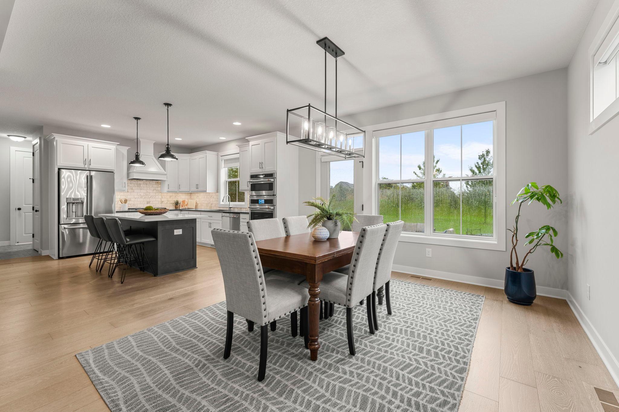 The open layout keeps the dining area connected to the kitchen and living room, creating an easy flow for meals, conversation, and entertaining.