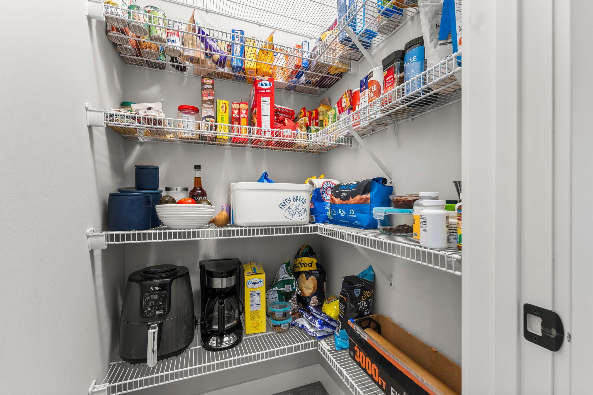 The convenient walk-in closet provides plenty of storage for your kitchen needs.