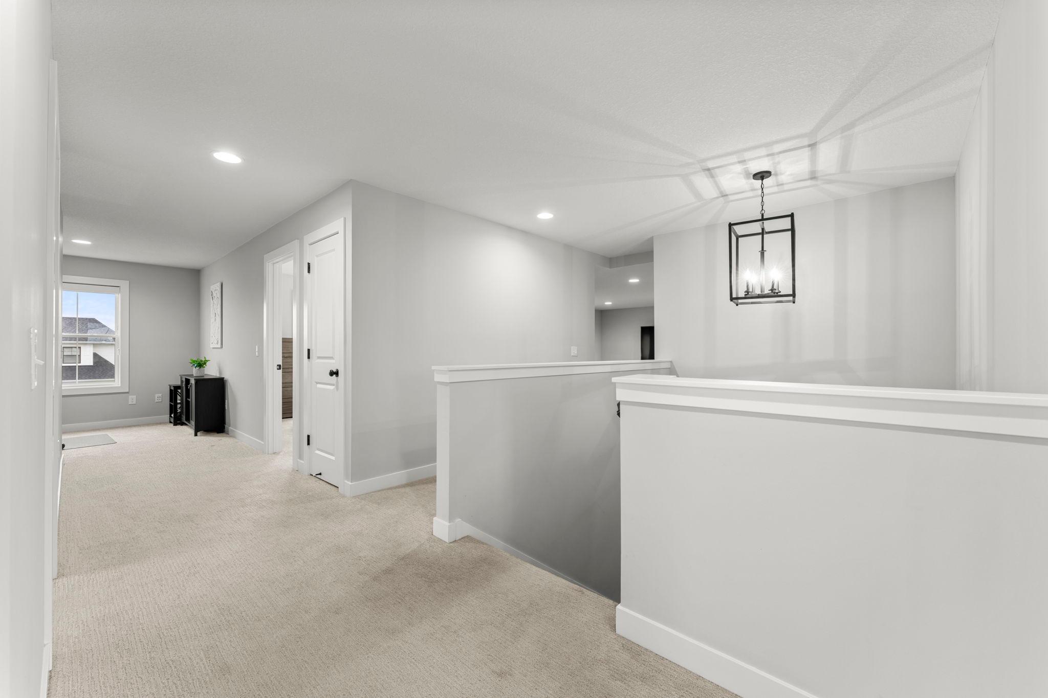 The upper level has a spacious landing and hallway leading to the four upper-level bedrooms, bonus space and large family room.
