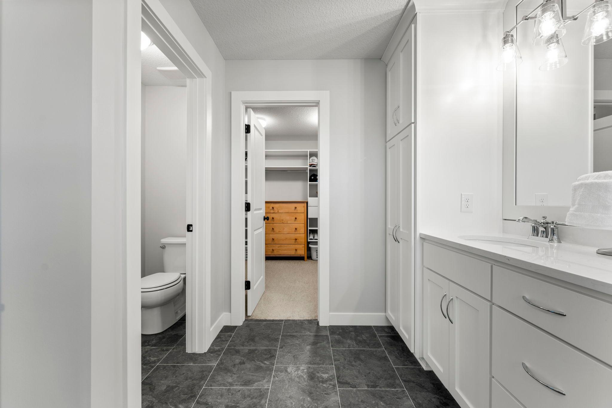 The private primary bathroom includes a separate water closet and access to the large walk-in closet.
