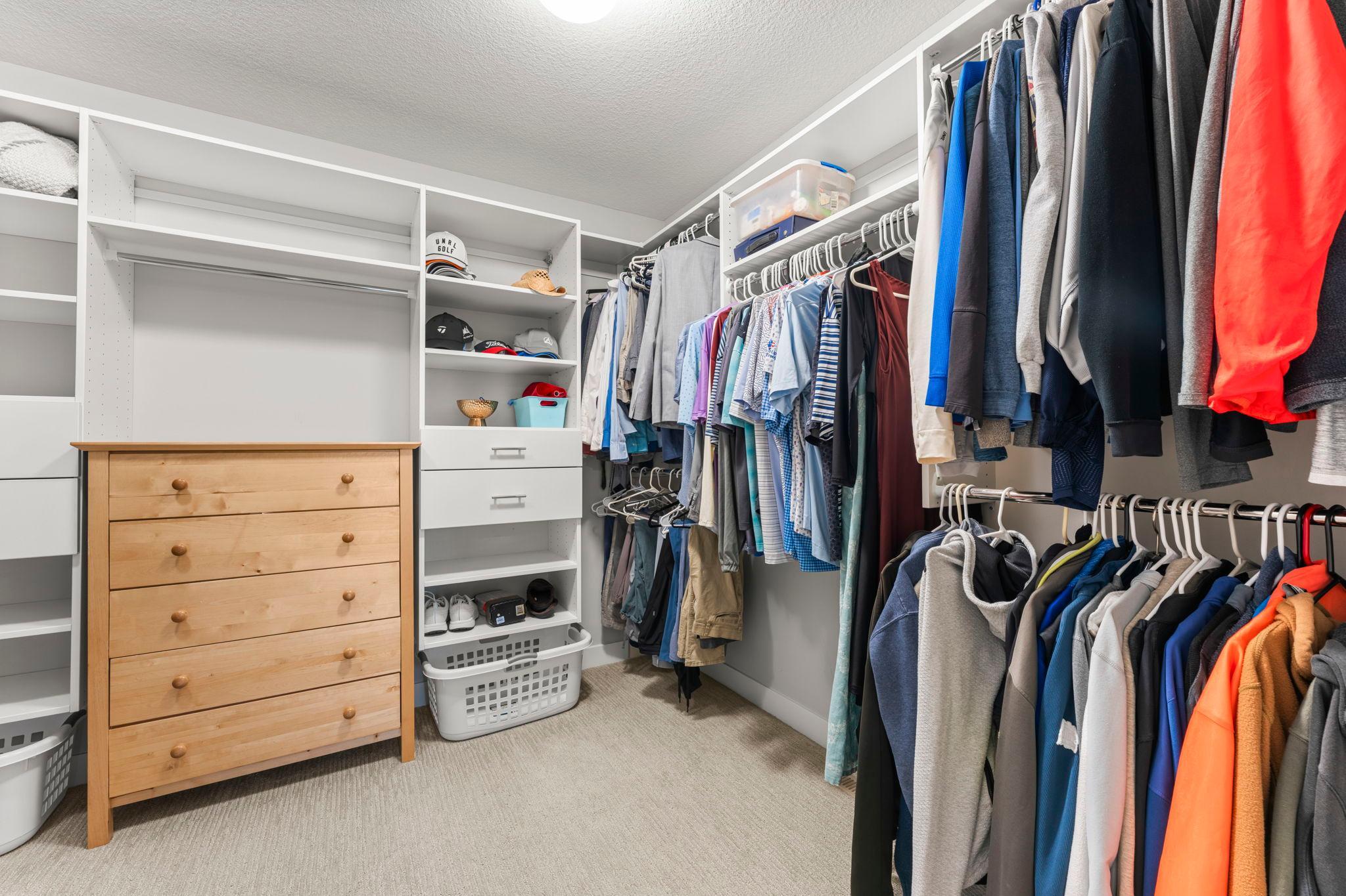 The spacious primary walk-in closet includes a built-in organization system and generous storage.