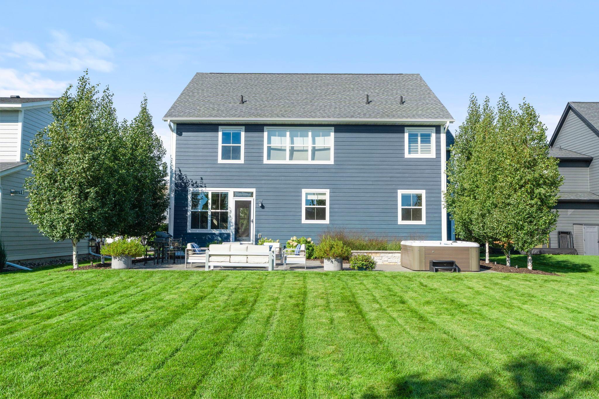Another view of the of the back of the home and the flat backyard.