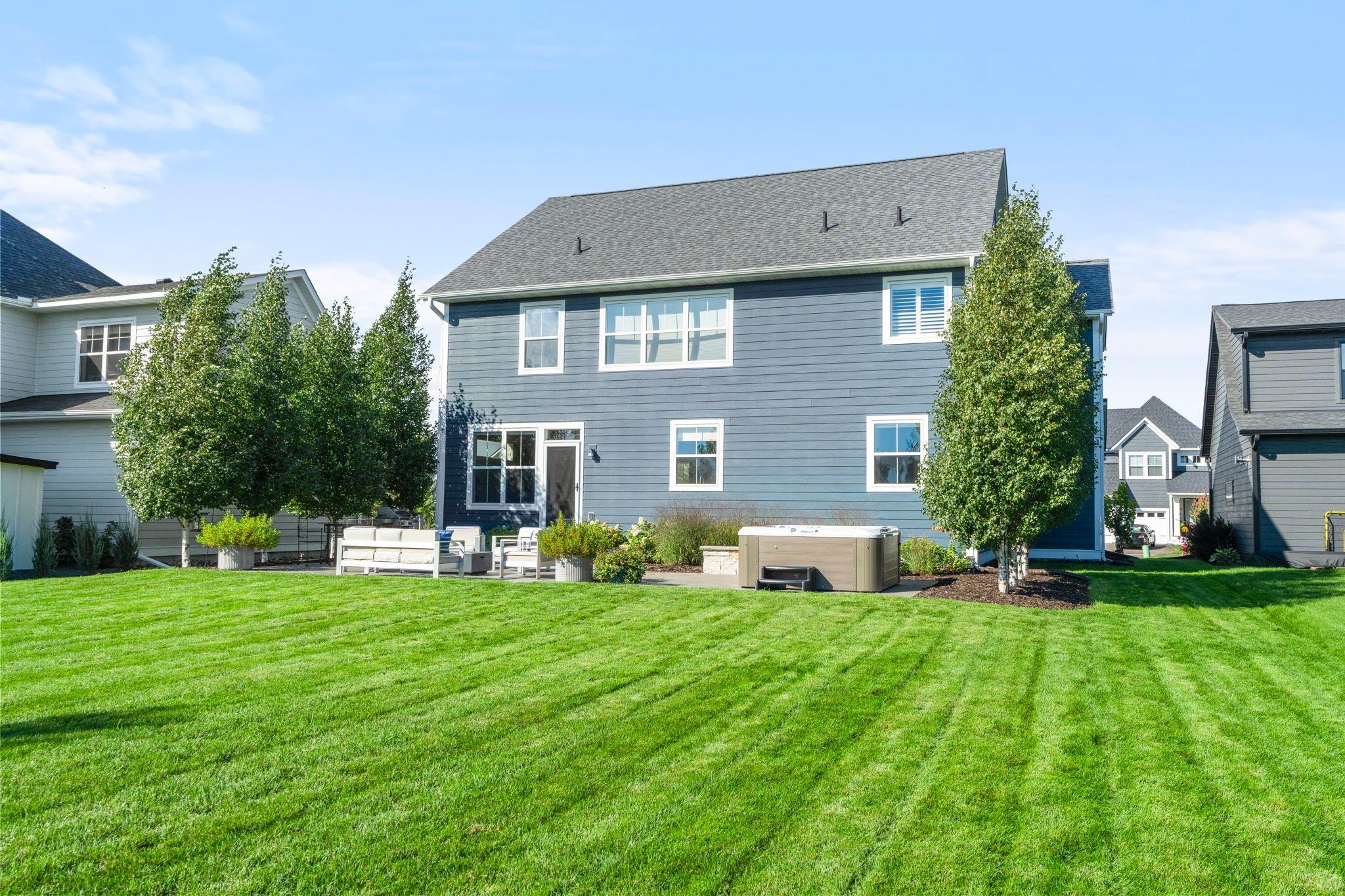 The backyard is spacious amd flat, perfect for entertaining. It features in-ground sprinklers and an invisible style fence.