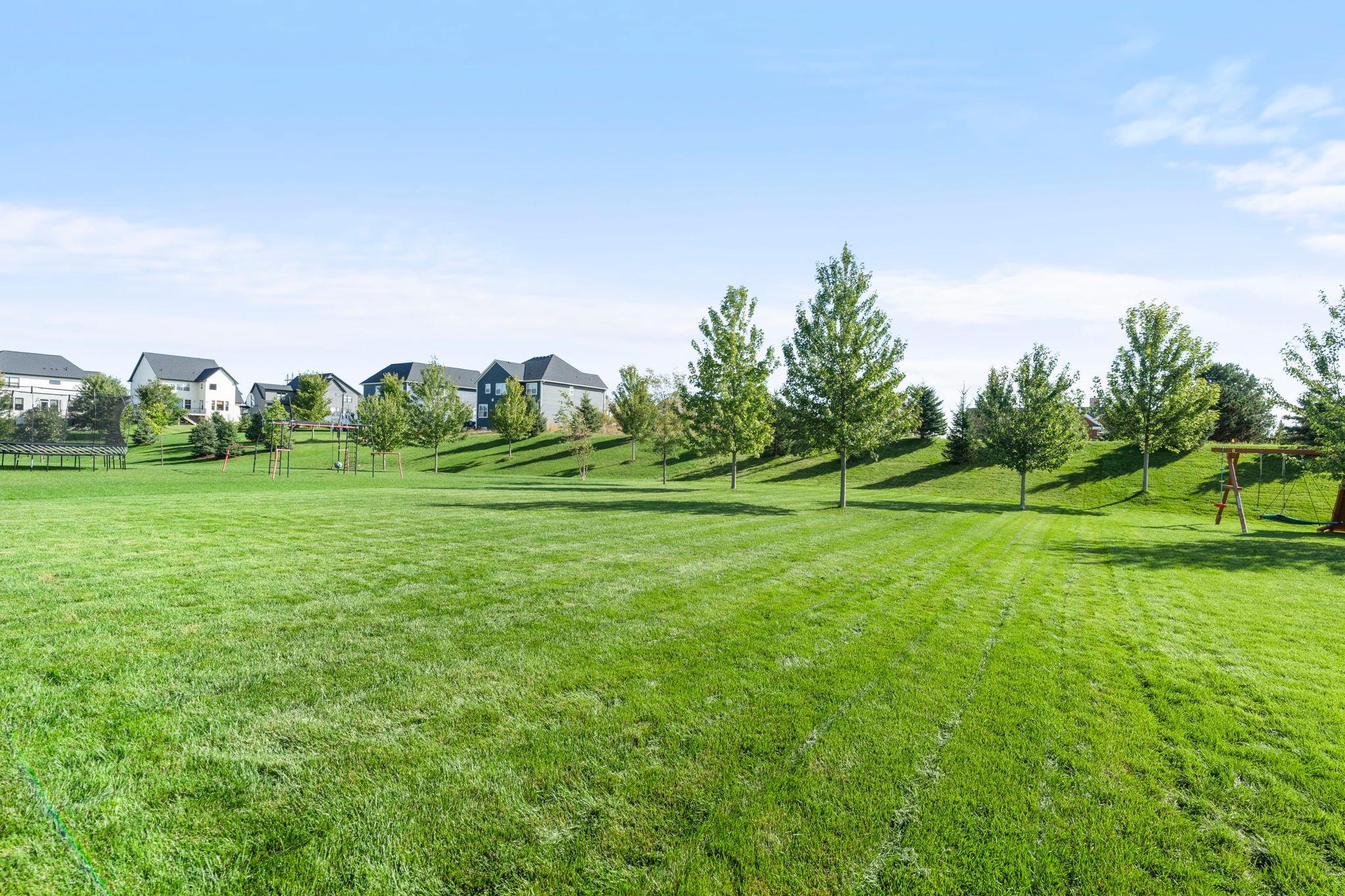 The backyard features a privacy berm at the back. Behind that is a utility building so there are no backyard neighbors.