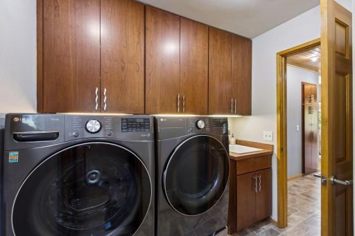 Laundry room is located just off the kitchen. It boasts plenty of storage for all your laundry essentials.