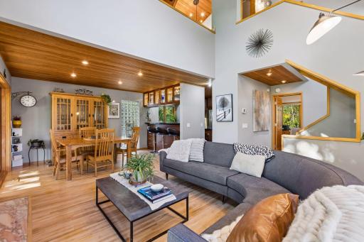 The open-concept layout flows naturally from the living area into the dining space, with custom woodwork, expansive windows, and architectural details adding character throughout.