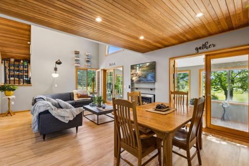 From the dining area, the open design and walls of windows bring the outdoors in while showcasing the home's unique architecture and generous living spaces.