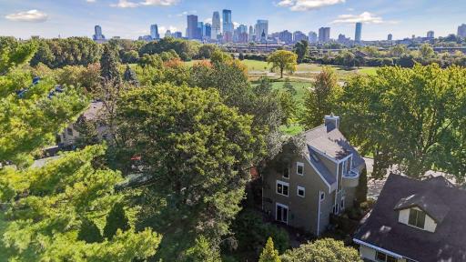 Elevated view highlighting the home's exceptional setting overlooking Bryn Mawr Meadows, with sweeping views toward the Minneapolis skyline.