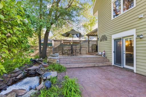 This home features a large deck and multiple patio areas overlook the beautifully landscaped yard, complete with mature gardens, a peaceful pond and a storage shed designed to complement the home.