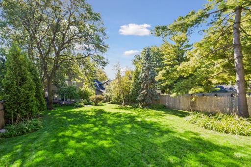 The fenced lot extends more than 200 feet deep, creating a remarkable sense of
space and privacy in the city.