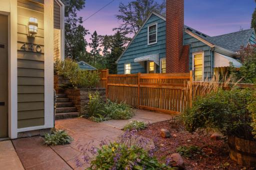A thoughtfully landscaped outdoor space offers privacy, mature gardens, and a charming setting ideal for relaxing or entertaining.