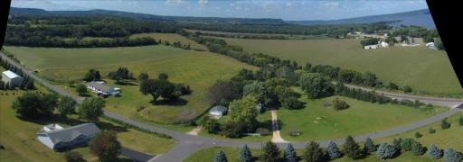 Lower land goes around and behind the two homes near railroad tracks