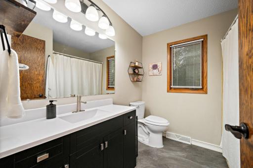 Fully renovated full bath with new LVP tile, updated vanity, tile tub surround, and a new toilet!