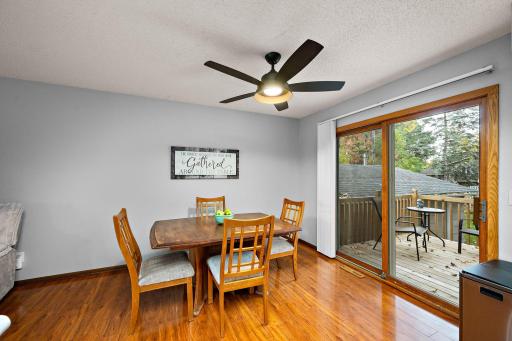 The dining area walks out to a brand-new deck overlooking a fully enclosed, 6-foot privacy-fenced backyard with a patio, storage shed, and two access gates
