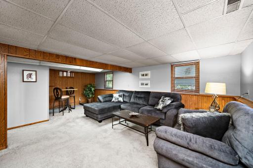 Downstairs features a spacious family room, a 3rd bedroom, a 3/4 bath with tile flooring, and dedicated laundry space