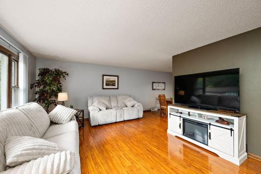 Open main floor layout with a bright living room with gleaming hardwood floors and an updated kitchen!