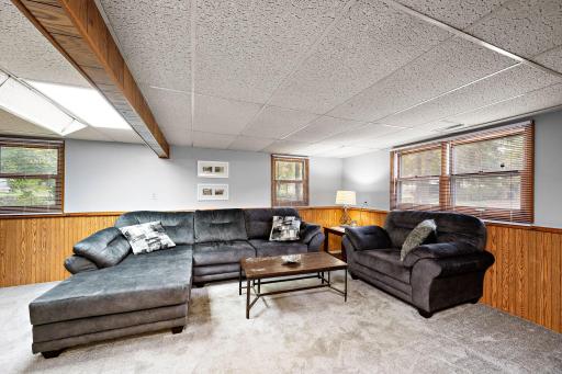 Downstairs features a spacious family room, a 3rd bedroom, a 3/4 bath with tile flooring, and dedicated laundry space