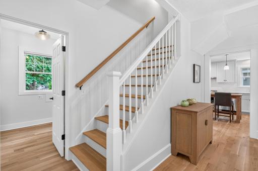 A newly constructed staircase creates a beautiful, functional connection to the upper level.