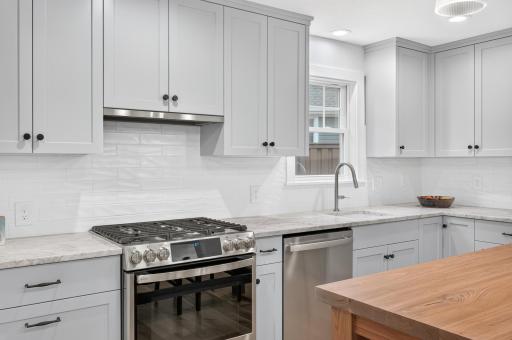 Notice the tile backsplash and gleaming quartzite counters.