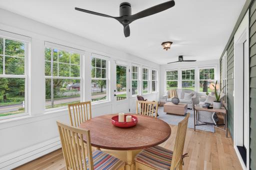The newly added four-season front porch is flooded with natural light, creating an inviting space to enjoy year-round.