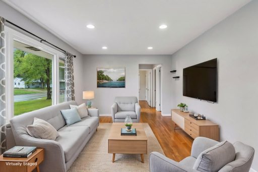 Step inside and you’ll immediately notice the charm of the original hardwood floors. Natural light pours through the living room picture window, creating a bright and welcoming space. Virtually staged.