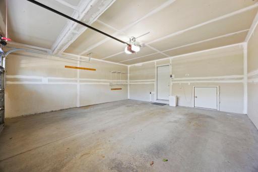 The attached two-car garage provides access to a spacious crawl space for additional storage.