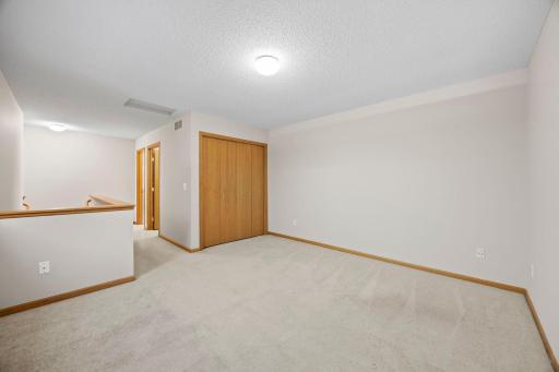Rounding out the upper level is a spacious loft area that provides flexible living space for a home office, sitting area, or additional gathering space.