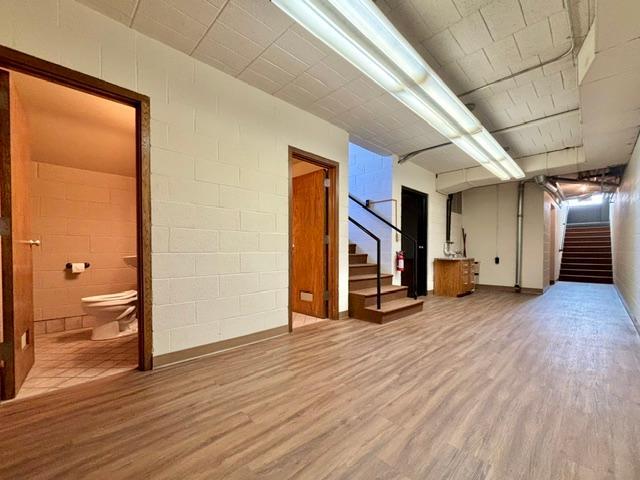Two restrooms are in the lower level and to the left here is another room that could be storage or rented out space. The door to the left before the steps in back is a large rentable space too. At top of the stairs is another entry from the alley.