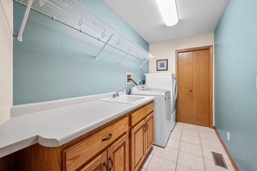 Main floor laundry with upgrade cabinetry