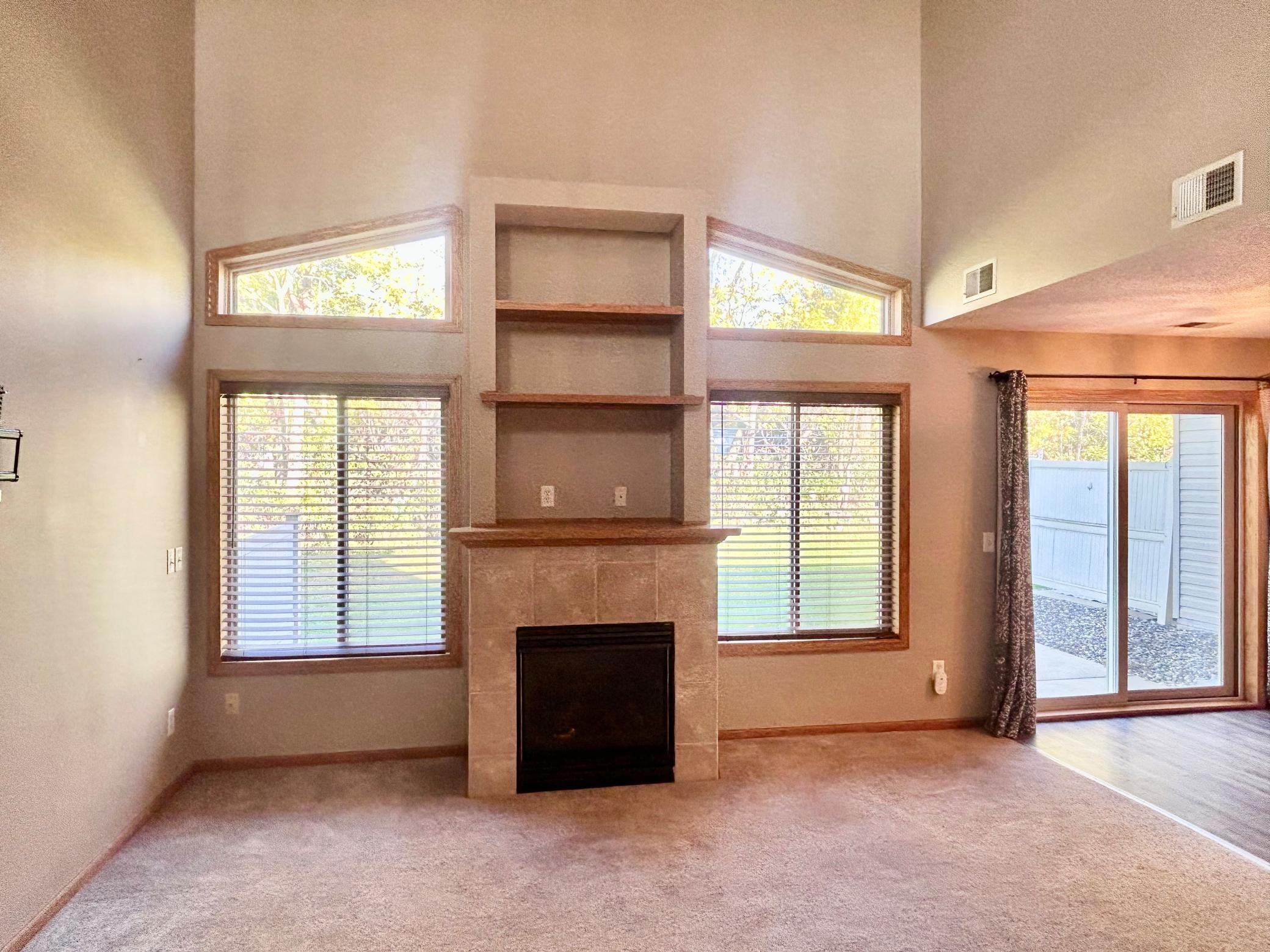 Great room with fireplace, vaulted ceilings and paired windows