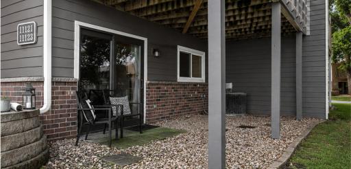 Walkout patio underneath the deck (color of exterior digitally rendered for new pain color)